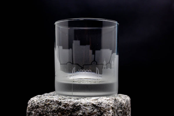 a shot glass sitting on top of a rock