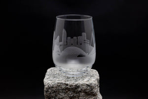 a wine glass sitting on top of a rock