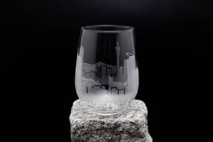 a glass sitting on top of a rock