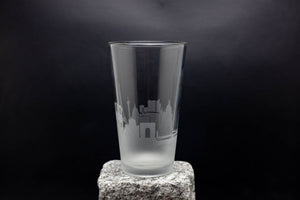 a tall glass sitting on top of a rock