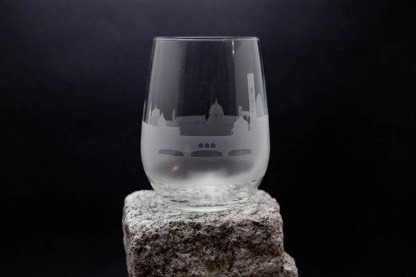 a wine glass sitting on top of a rock