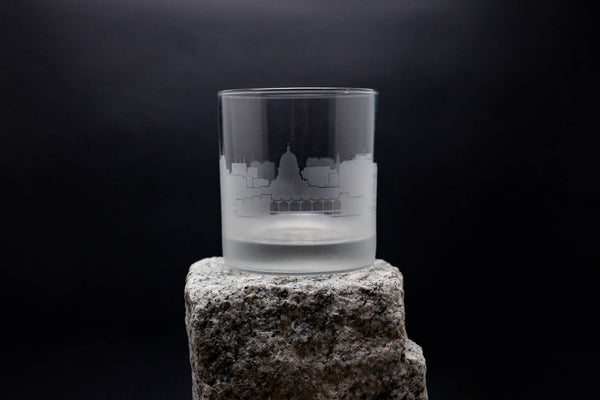 a clear glass sitting on top of a rock