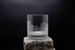 a glass sitting on top of a rock