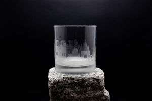 a glass sitting on top of a rock