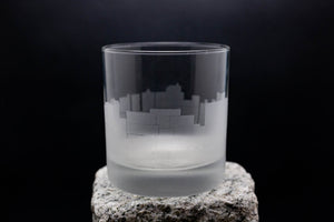 a glass sitting on top of a rock