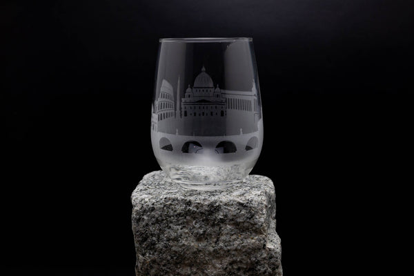 a glass sitting on top of a rock