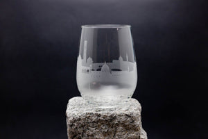 a clear glass sitting on top of a rock