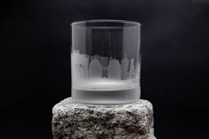 a glass sitting on top of a rock