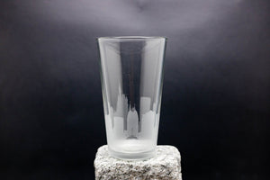 a tall glass sitting on top of a rock