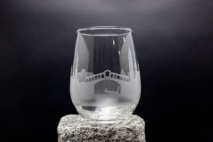 a wine glass sitting on top of a rock