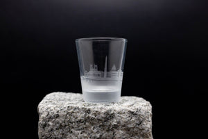 a shot glass sitting on top of a rock