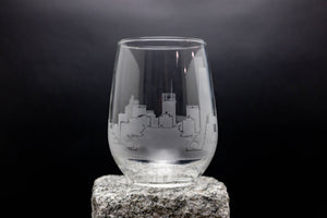 a wine glass with a picture of a city on it