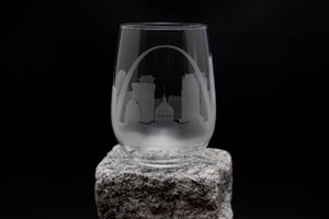 a wine glass sitting on top of a rock