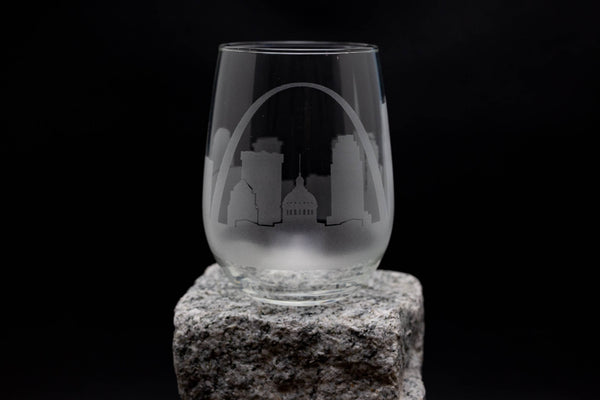 a wine glass sitting on top of a rock