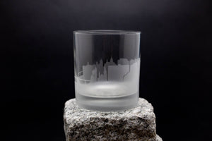 a glass sitting on top of a rock