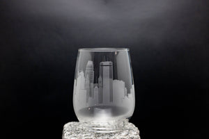 a glass with a city skyline etched on it