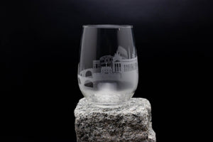 a glass sitting on top of a rock