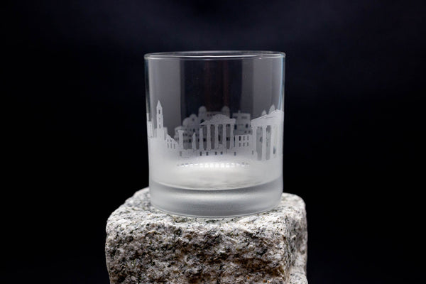 a glass sitting on top of a rock