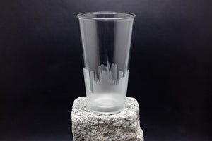 a tall glass sitting on top of a rock