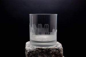 a shot glass sitting on top of a rock