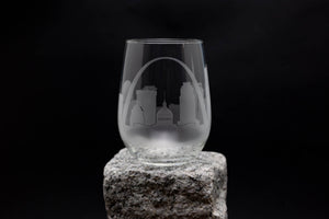 a wine glass sitting on top of a rock