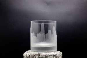 a glass with a city skyline etched on it