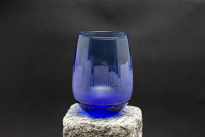 a blue glass sitting on top of a rock