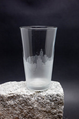 a shot glass sitting on top of a rock