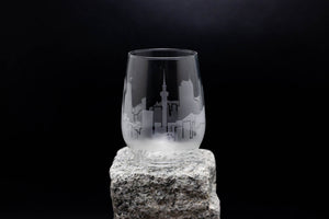 a glass sitting on top of a rock