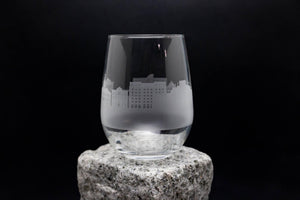 a glass sitting on top of a rock