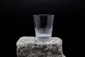 a shot glass sitting on top of a rock