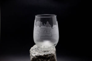 a wine glass sitting on top of a rock