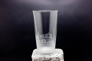 a tall glass sitting on top of a rock