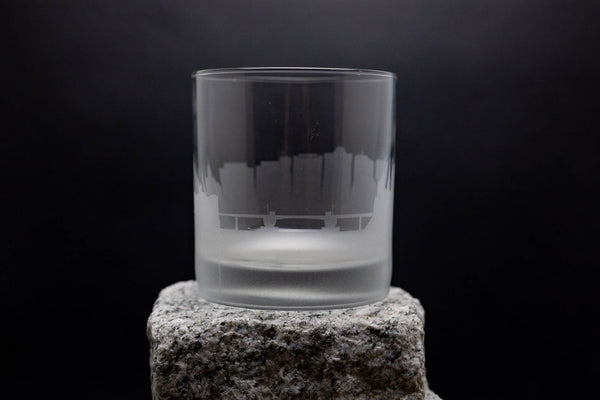 a glass sitting on top of a rock