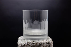 a glass sitting on top of a rock