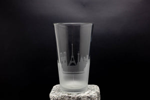 a tall glass sitting on top of a rock