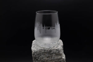 a glass sitting on top of a rock