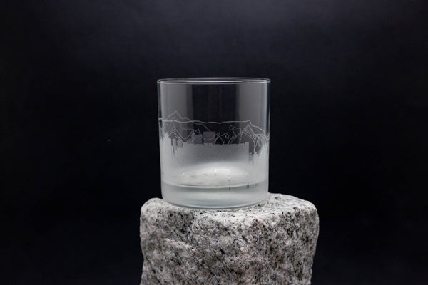 a glass sitting on top of a rock