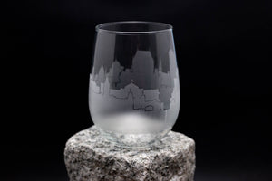 a wine glass sitting on top of a rock