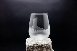 a glass sitting on top of a rock