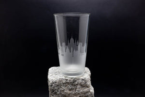 a tall glass sitting on top of a rock