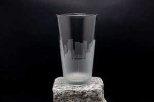 a tall glass sitting on top of a rock