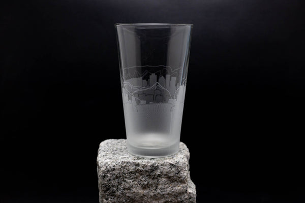 a glass sitting on top of a rock