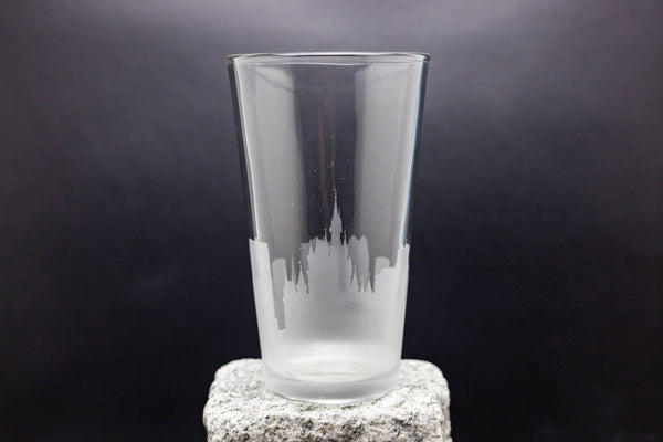 a tall glass sitting on top of a rock