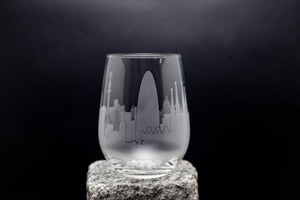 a glass with a city skyline etched on it