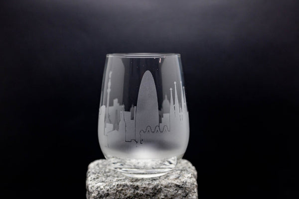 a glass with a city skyline etched on it