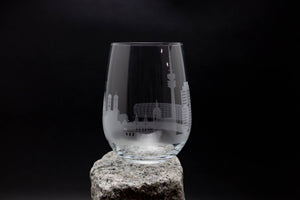 a glass sitting on top of a rock