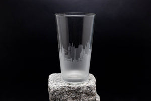 a tall glass sitting on top of a rock