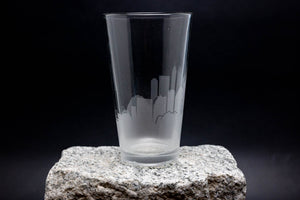 a tall glass sitting on top of a rock