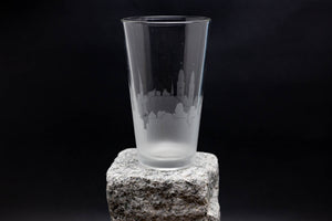 a tall glass sitting on top of a rock